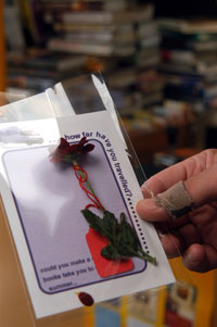 thumb with worn fabric plaster holding card & flower given to all participants